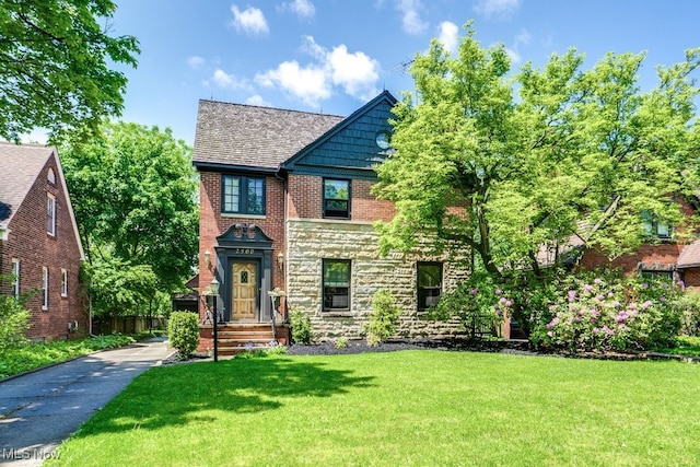 2500 Eaton Rd, University Heights, OH 44118 - tudor-style house with a front lawn and stone siding