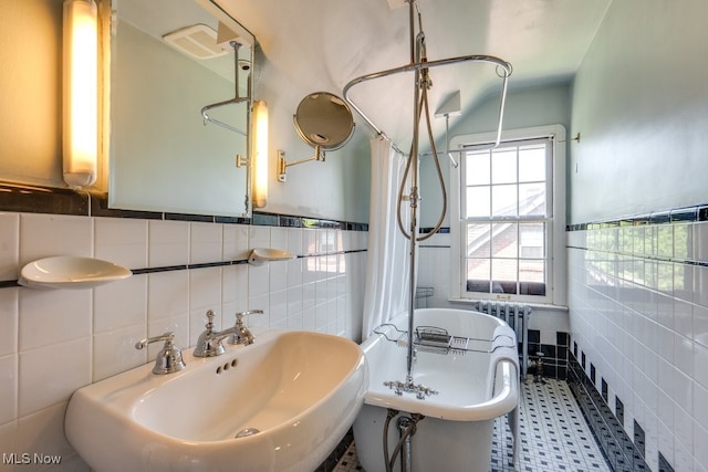 2500 Eaton Rd, University Heights, OH 44118 - bathroom featuring tile walls, a sink, a freestanding bath, radiator heating unit, and curtained shower