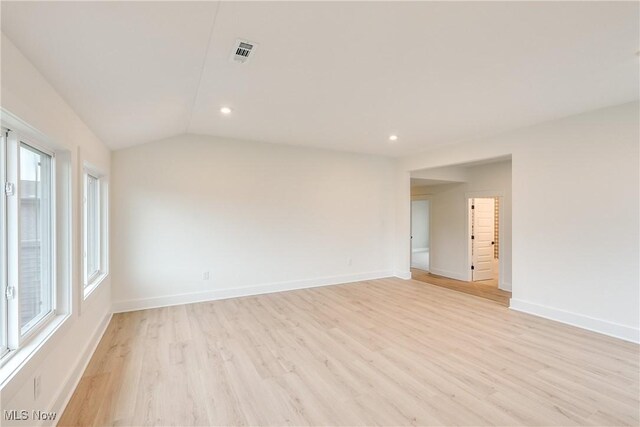 S/L12 Neptune Oval, Solon, OH 44139 - spare room featuring light wood-style floors, baseboards, recessed lighting, and lofted ceiling