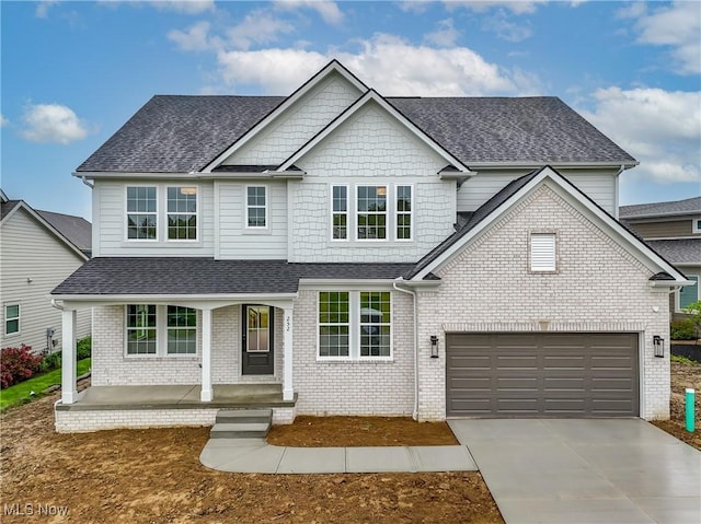 S/L12 Neptune Oval, Solon, OH 44139 - view of front facade featuring a shingled roof, a porch, concrete driveway, and brick siding