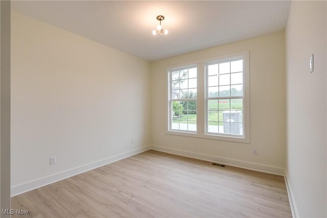 S/L12 Neptune Oval, Solon, OH 44139 - spare room with light wood finished floors and baseboards