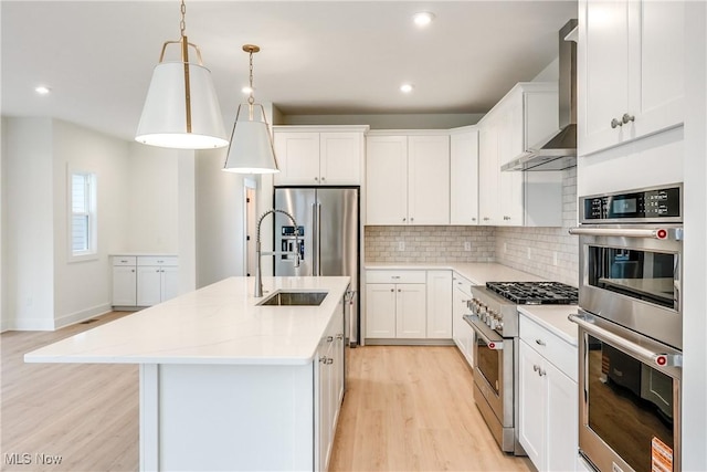 S/L12 Neptune Oval, Solon, OH 44139 - kitchen with stainless steel appliances, wall chimney exhaust hood, light wood-style floors, a sink, and decorative backsplash