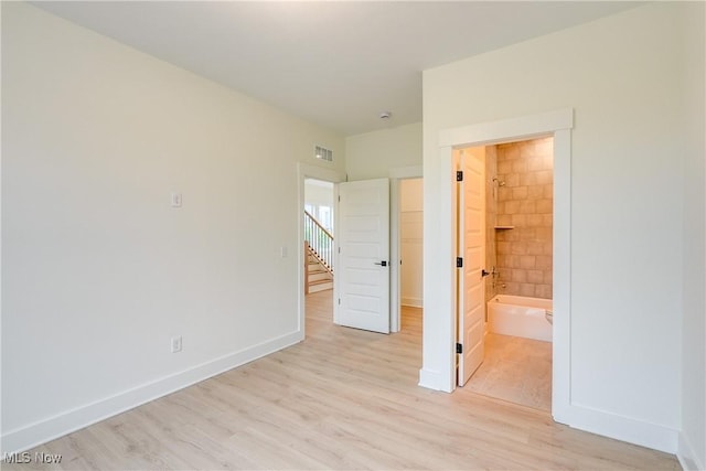 S/L12 Neptune Oval, Solon, OH 44139 - unfurnished bedroom with light wood-type flooring, baseboards, and connected bathroom