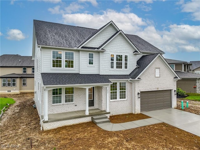 S/L12 Neptune Oval, Solon, OH 44139 - view of front of property featuring a shingled roof, a porch, driveway, and brick siding