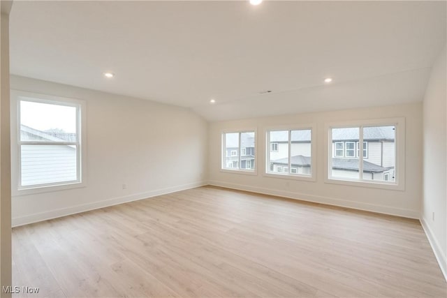 S/L12 Neptune Oval, Solon, OH 44139 - empty room featuring light wood-style flooring, baseboards, recessed lighting, and lofted ceiling
