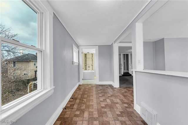 4611 W 41st St, Cleveland, OH 44109 - hallway featuring brick patterned flooring and baseboards