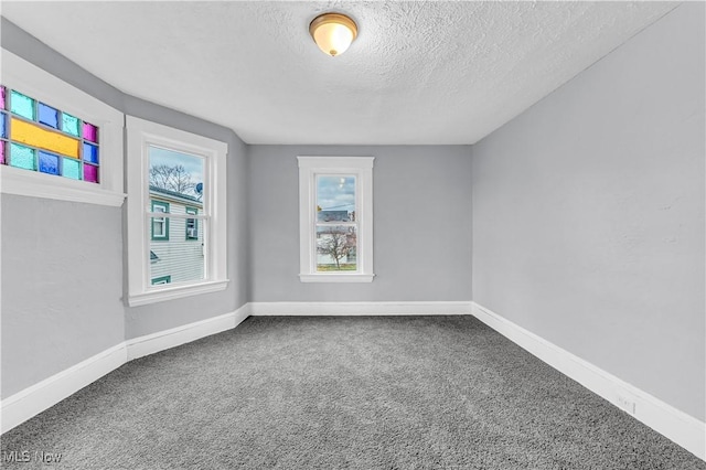 4611 W 41st St, Cleveland, OH 44109 - spare room with a textured ceiling, carpet, and baseboards