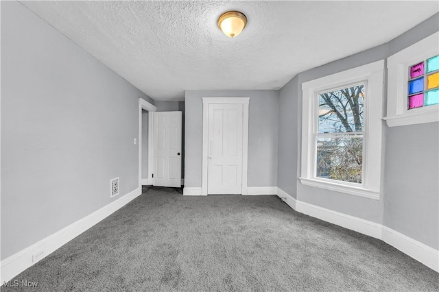 4611 W 41st St, Cleveland, OH 44109 - unfurnished bedroom featuring carpet flooring, a textured ceiling, baseboards, and a closet
