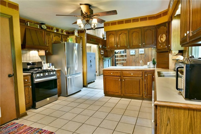 6416 Wilson Sharpsville Rd, Fowler, OH 44418 - kitchen featuring appliances with stainless steel finishes, premium range hood, a ceiling fan, light countertops, and light tile patterned floors