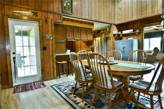 6416 Wilson Sharpsville Rd, Fowler, OH 44418 - dining space with wooden walls and light wood-style floors