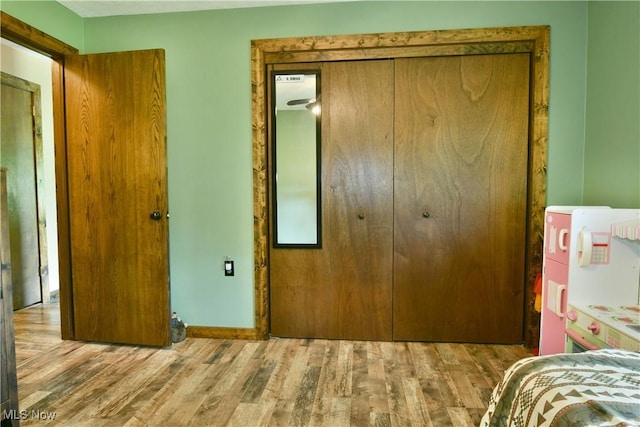 6416 Wilson Sharpsville Rd, Fowler, OH 44418 - bedroom with wood finished floors, a closet, and baseboards