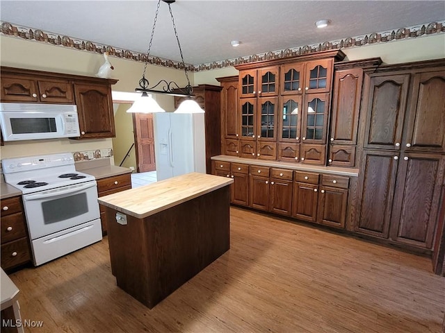 3172 Kinata Ct, West Salem, OH 44287 - kitchen featuring white appliances, butcher block countertops, light wood-type flooring, decorative light fixtures, and a kitchen island