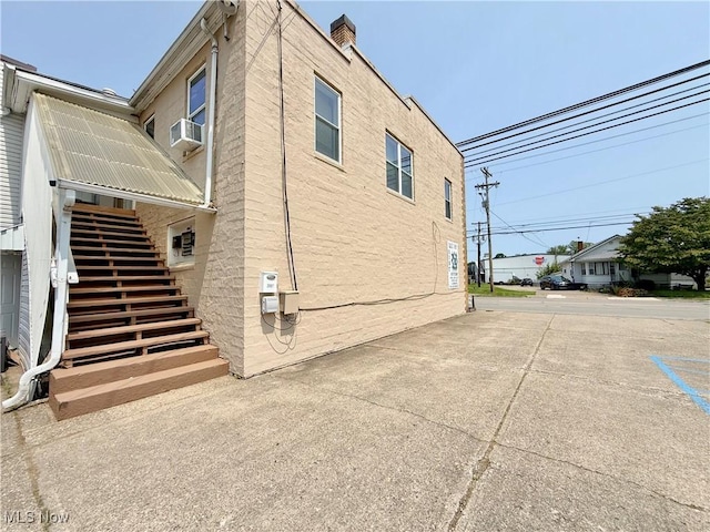 2007 Washington Blvd, Belpre, OH 45714 - view of home's exterior with stairway, a chimney, and cooling unit