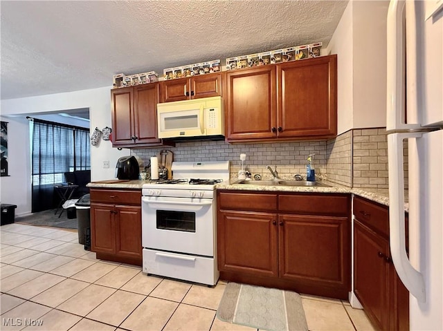 2007 Washington Blvd, Belpre, OH 45714 - kitchen featuring white appliances, a sink, light countertops, decorative backsplash, and a textured ceiling
