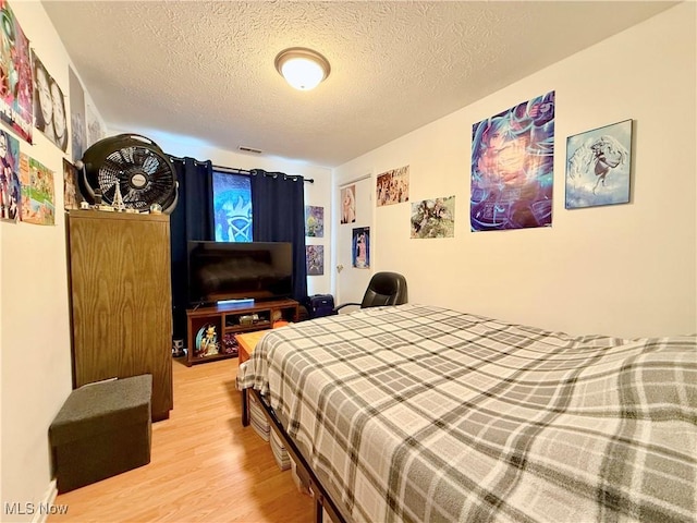 2007 Washington Blvd, Belpre, OH 45714 - bedroom with wood finished floors and a textured ceiling