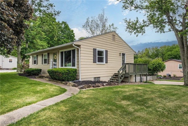 715 Locust St S, Canal Fulton, OH 44614 - ranch-style house with a front yard and a wooden deck