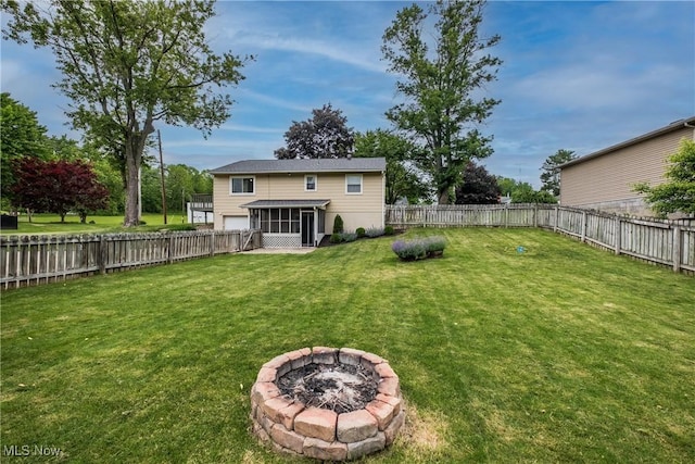 715 Locust St S, Canal Fulton, OH 44614 - view of yard featuring a sunroom, an outdoor fire pit, and a garage