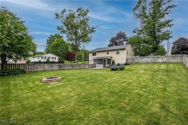 715 Locust St S, Canal Fulton, OH 44614 - view of yard with a sunroom and a fire pit