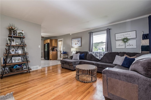 715 Locust St S, Canal Fulton, OH 44614 - living room with light wood finished floors and crown molding