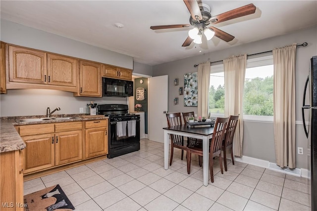 715 Locust St S, Canal Fulton, OH 44614 - kitchen featuring black appliances, ceiling fan, a sink, and baseboards
