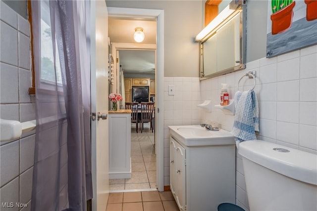 715 Locust St S, Canal Fulton, OH 44614 - bathroom featuring tile patterned floors, vanity, tile walls, and toilet