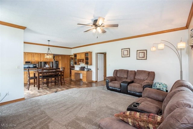 18230 James Way, Doylestown, OH 44230 - carpeted living area featuring a ceiling fan, crown molding, and baseboards