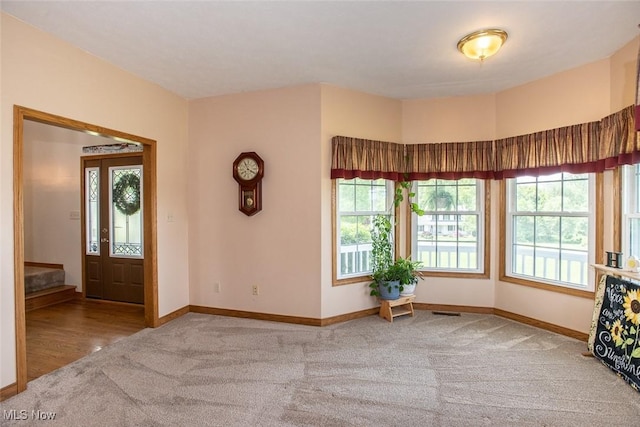 18230 James Way, Doylestown, OH 44230 - foyer featuring carpet flooring, healthy amount of natural light, and baseboards