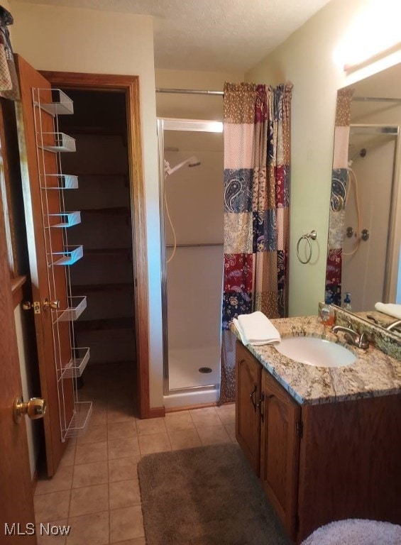 130 Maze Rd, Belpre, OH 45714 - bathroom with a stall shower, tile patterned floors, and vanity