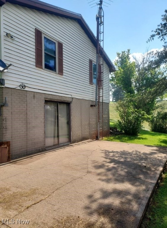 130 Maze Rd, Belpre, OH 45714 - rear view of property featuring a patio area and brick siding