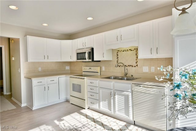 100 Turnberry Ct NE, Warren, OH 44484 - kitchen with white appliances, a sink, light countertops, white cabinetry, and recessed lighting