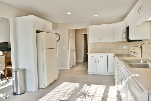 100 Turnberry Ct NE, Warren, OH 44484 - kitchen featuring white appliances, a sink, light wood-style flooring, light countertops, and white cabinets