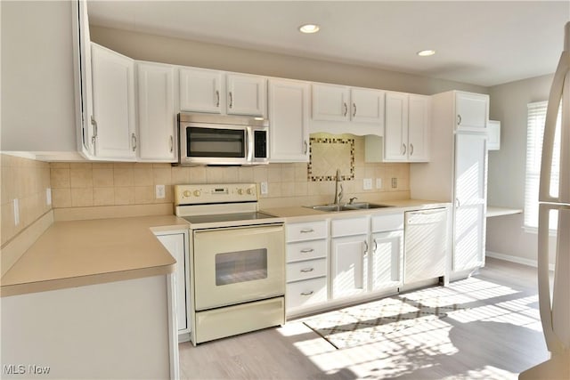 100 Turnberry Ct NE, Warren, OH 44484 - kitchen with white appliances, a sink, light wood-style floors, white cabinets, and light countertops