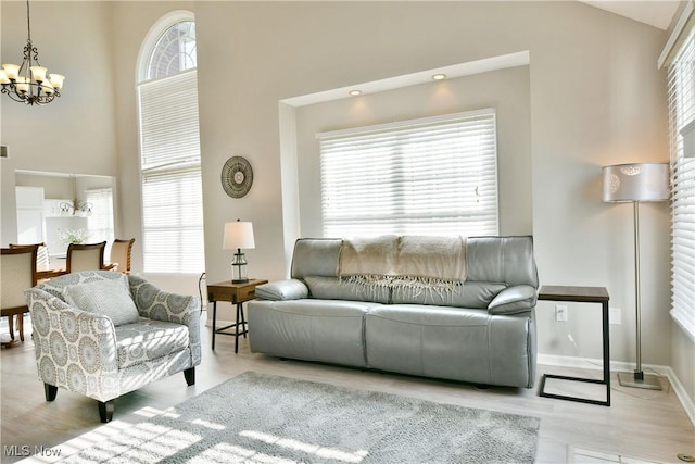 100 Turnberry Ct NE, Warren, OH 44484 - living room with a chandelier, wood finished floors, a towering ceiling, and baseboards
