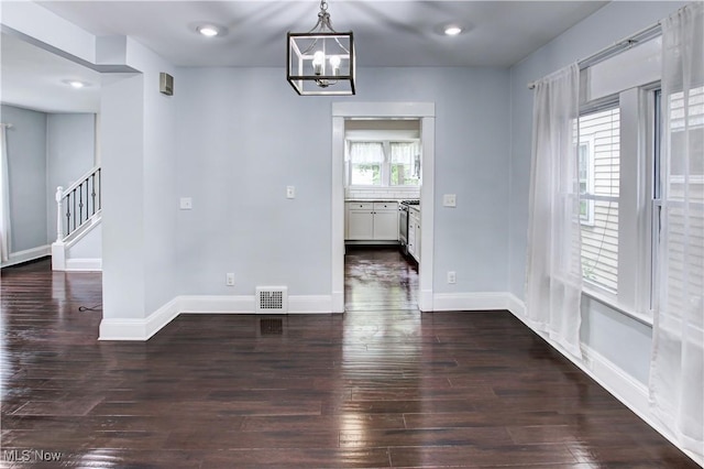 2577 Idlewood Rd, Cleveland Heights, OH 44118 - unfurnished dining area with hardwood / wood-style flooring, a chandelier, stairway, and baseboards