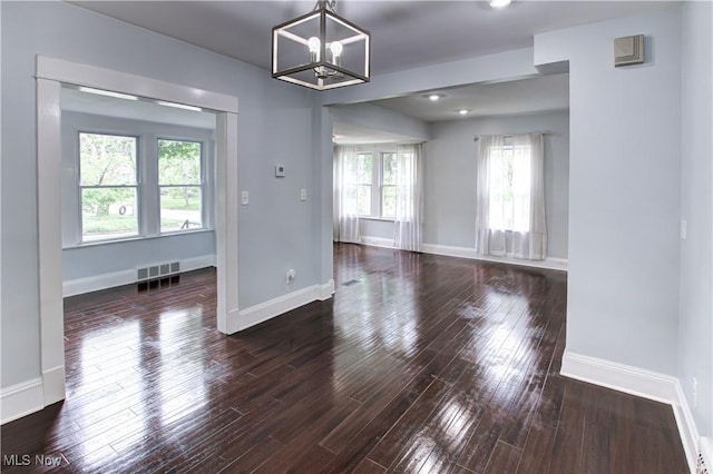 2577 Idlewood Rd, Cleveland Heights, OH 44118 - spare room featuring a chandelier, wood finished floors, and baseboards