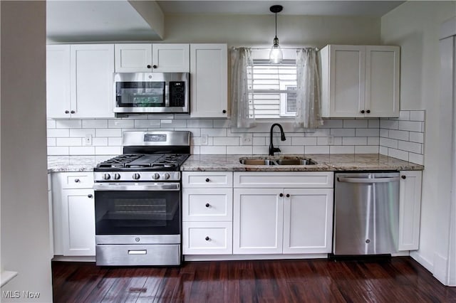 2577 Idlewood Rd, Cleveland Heights, OH 44118 - kitchen featuring stainless steel appliances, a sink, light stone countertops, white cabinetry, and tasteful backsplash