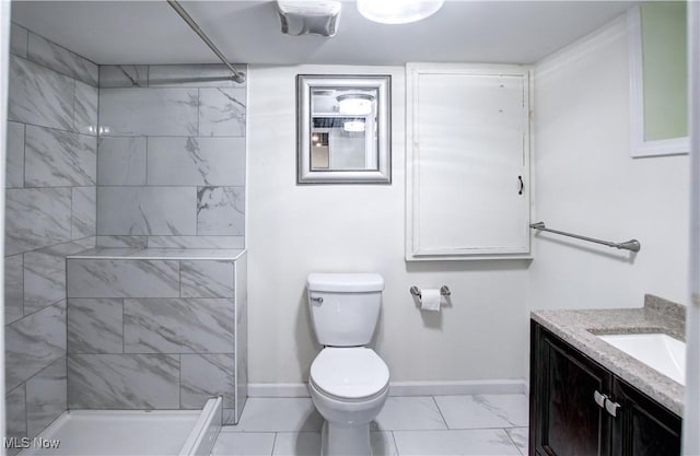 2577 Idlewood Rd, Cleveland Heights, OH 44118 - bathroom with vanity, marble finish flooring, toilet, tiled shower, and baseboards