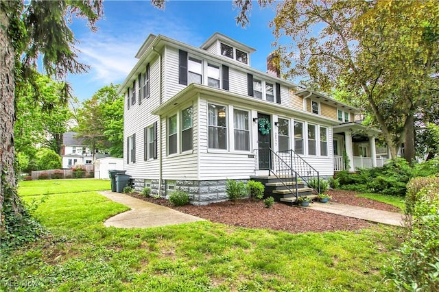 2577 Idlewood Rd, Cleveland Heights, OH 44118 - american foursquare style home featuring a chimney and a front yard