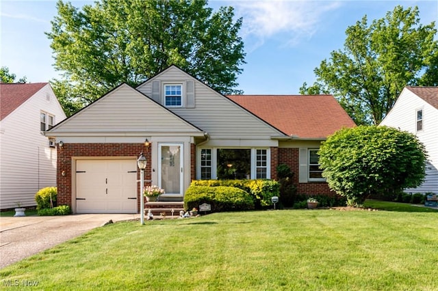 23903 E Baintree Rd, Beachwood, OH 44122 - view of front of house with brick siding, a garage, concrete driveway, and a front yard