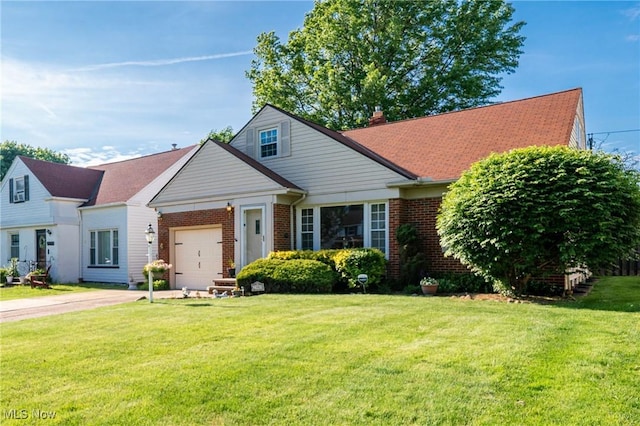 23903 E Baintree Rd, Beachwood, OH 44122 - view of front of house featuring an attached garage, concrete driveway, a front yard, and brick siding