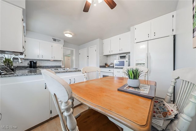 23903 E Baintree Rd, Beachwood, OH 44122 - kitchen with tasteful backsplash, a ceiling fan, white appliances, and white cabinets