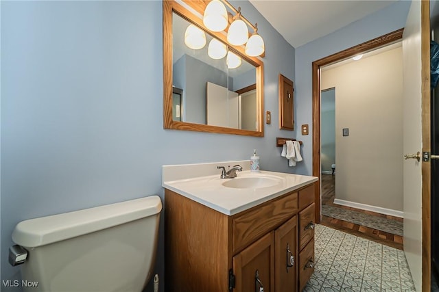 23903 E Baintree Rd, Beachwood, OH 44122 - bathroom featuring toilet, vanity, and baseboards