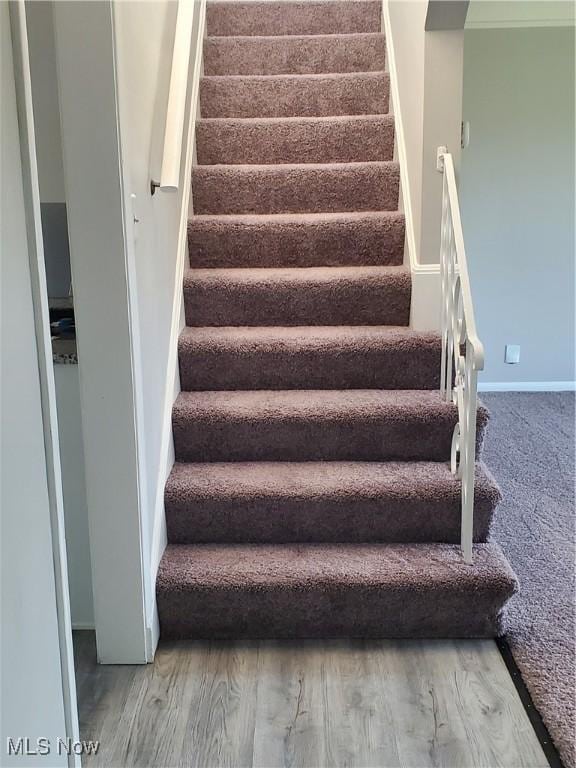 7007 Biddulph Rd, Brooklyn, OH 44144 - stairway featuring wood finished floors and baseboards