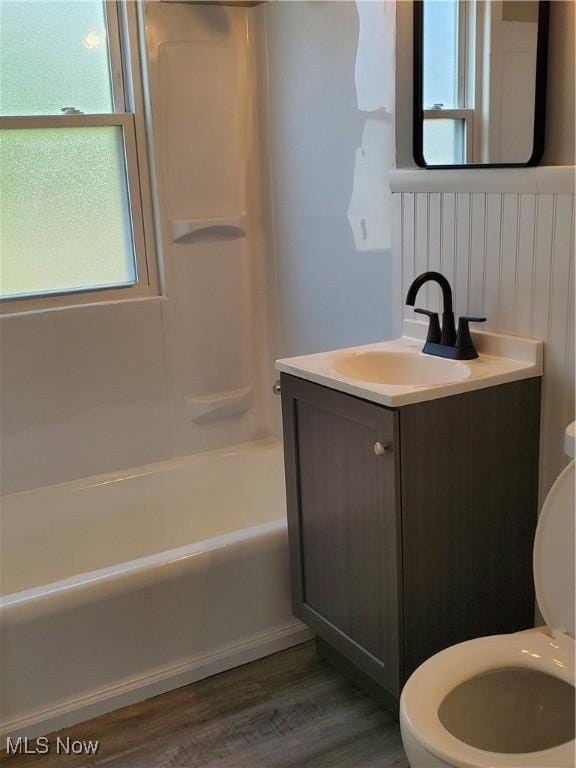 7007 Biddulph Rd, Brooklyn, OH 44144 - bathroom featuring toilet, vanity, plenty of natural light, and wood finished floors