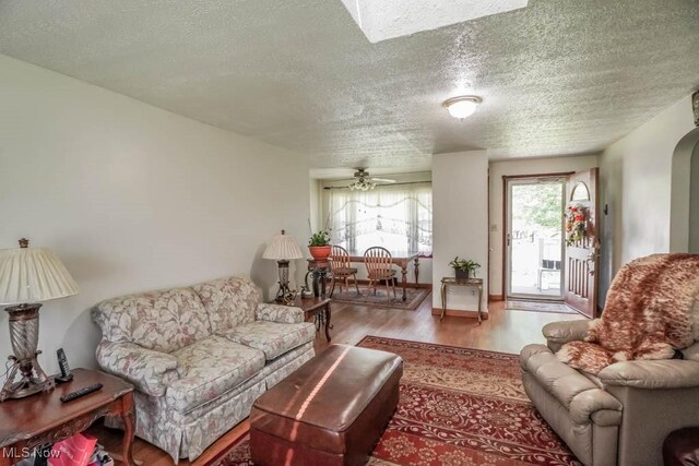 5920 Renninger Rd, New Franklin, OH 44319 - living room featuring wood finished floors, a textured ceiling, and ceiling fan