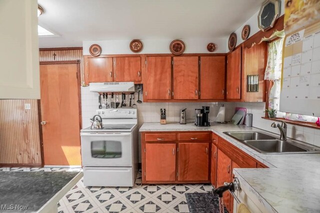 5920 Renninger Rd, New Franklin, OH 44319 - kitchen featuring white electric range, under cabinet range hood, a sink, light countertops, and backsplash