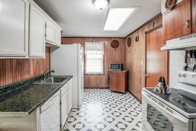 5920 Renninger Rd, New Franklin, OH 44319 - kitchen featuring appliances with stainless steel finishes, wood walls, under cabinet range hood, dark countertops, and white cabinetry