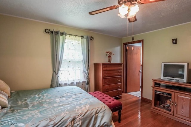 5920 Renninger Rd, New Franklin, OH 44319 - bedroom with wood finished floors, a textured ceiling, ornamental molding, and a ceiling fan
