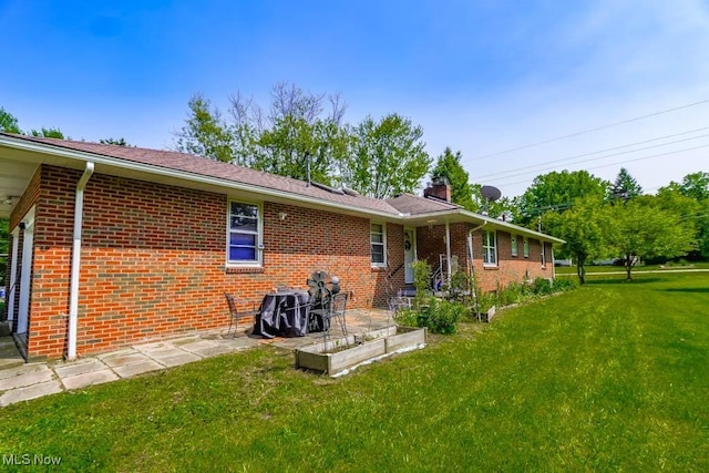 5920 Renninger Rd, New Franklin, OH 44319 - back of property featuring a yard, brick siding, a vegetable garden, and a chimney
