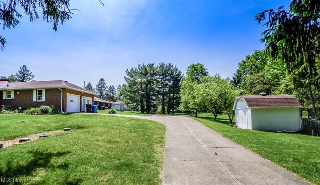 5920 Renninger Rd, New Franklin, OH 44319 - view of grassy yard with an attached garage and driveway